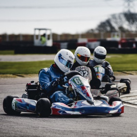 a-group-of-three-go-karts-racing-around-a-circuit